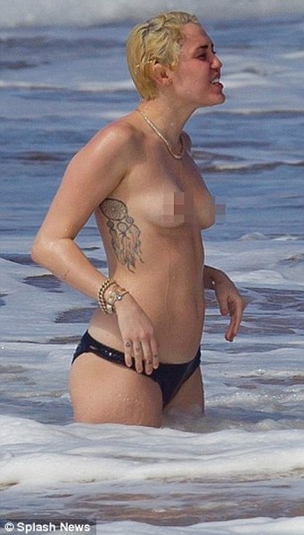 Miley Cyrus topless in the ocean with boyfriend Patrick Schwarzenegger 
